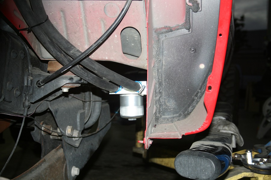Coolant filter mounted under driver's floor board